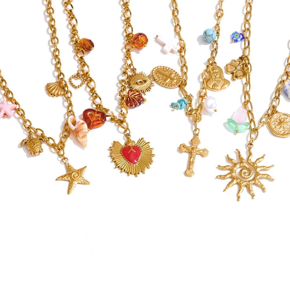 Gold-plated necklace with sun, moon, and star charms styled as a celestial-inspired everyday piece.
