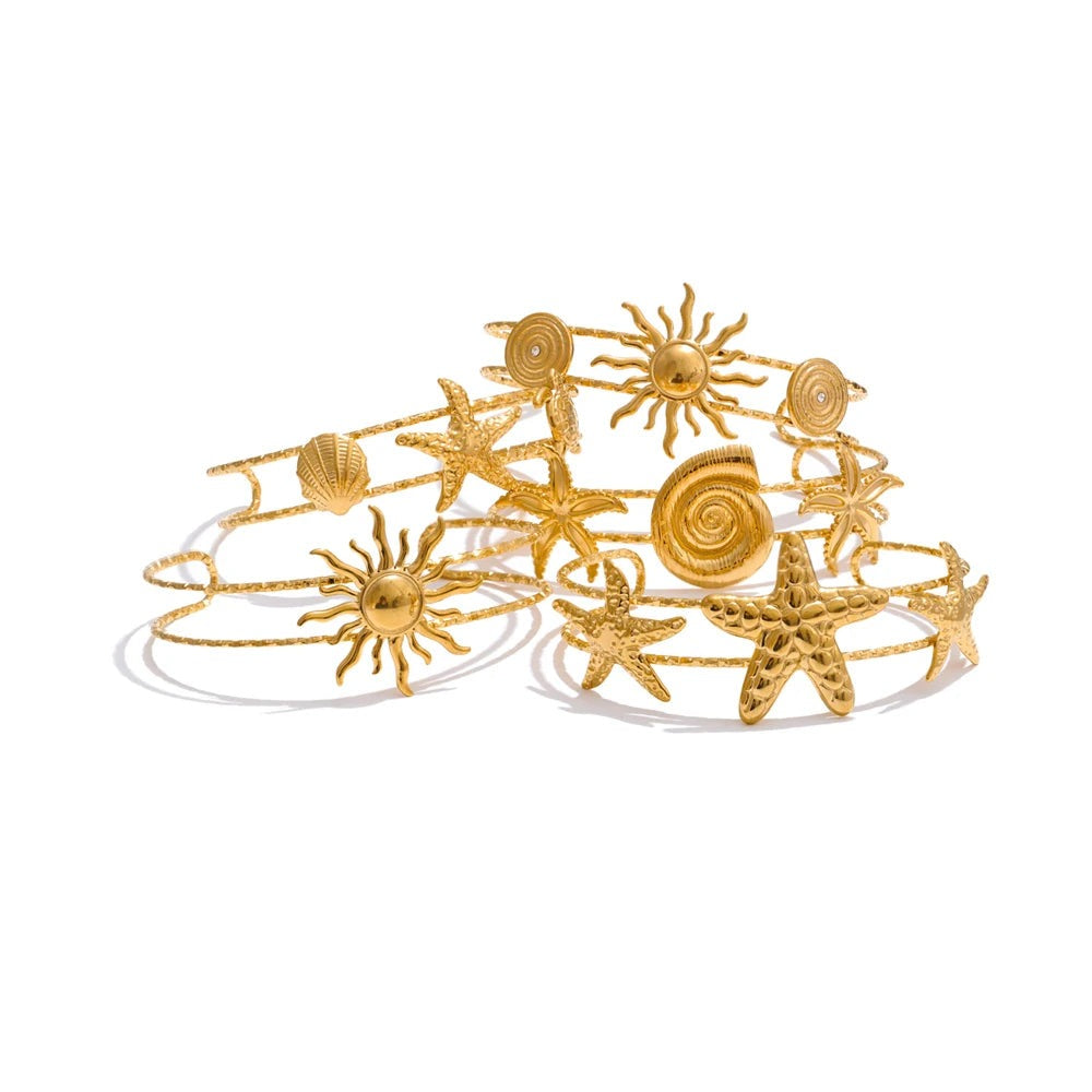 Gold-plated cuff bracelet with shell and sun charms for summer wear