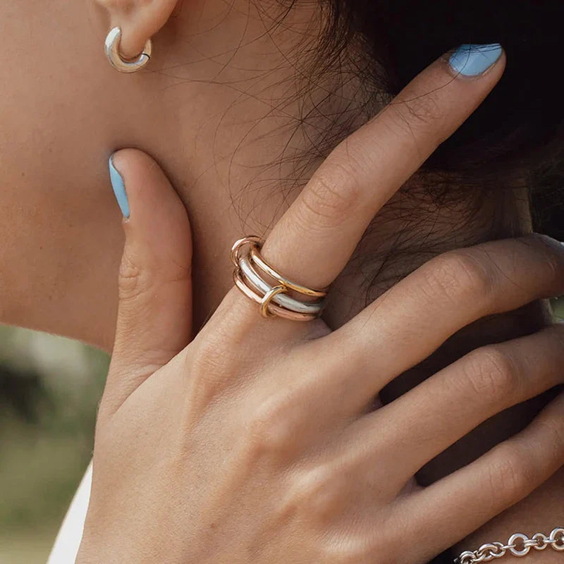 Minimal stainless steel ring stack worn across two fingers