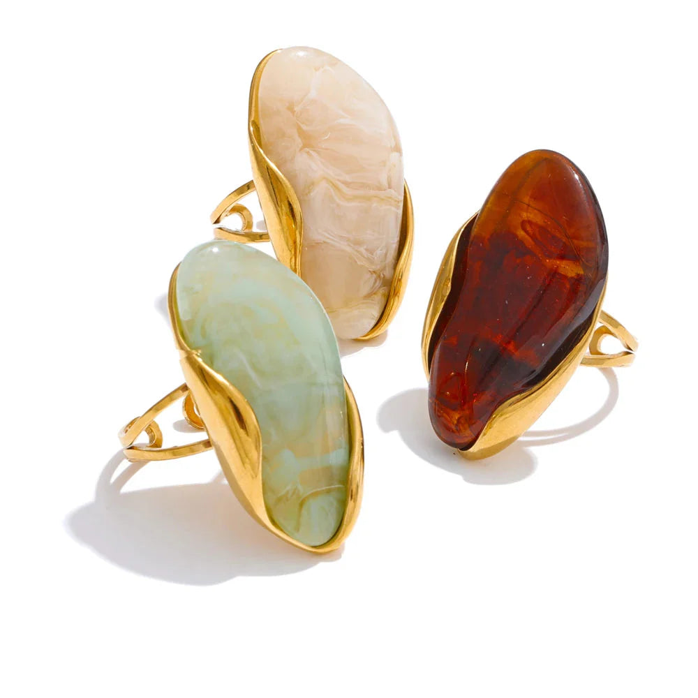 Green resin geometric ring in gold-plated stainless steel, styled for the green stone jewelry trend