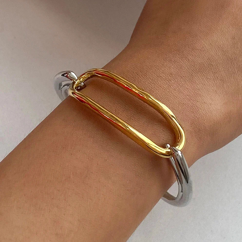 Two-tone oval link cuff bracelet combining gold and silver stainless steel