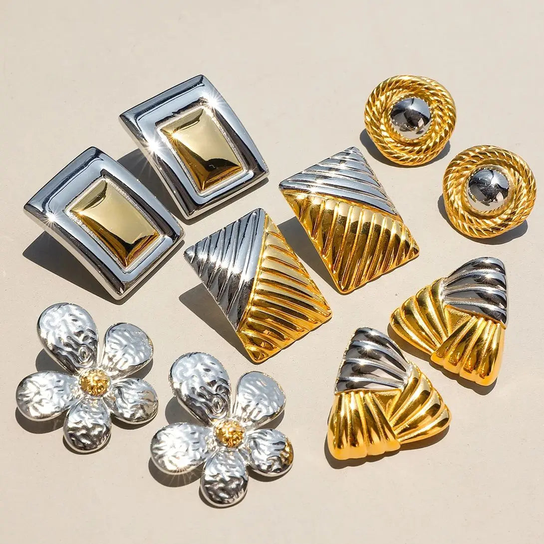 Two-tone statement hoop earrings worn as a single bold pair