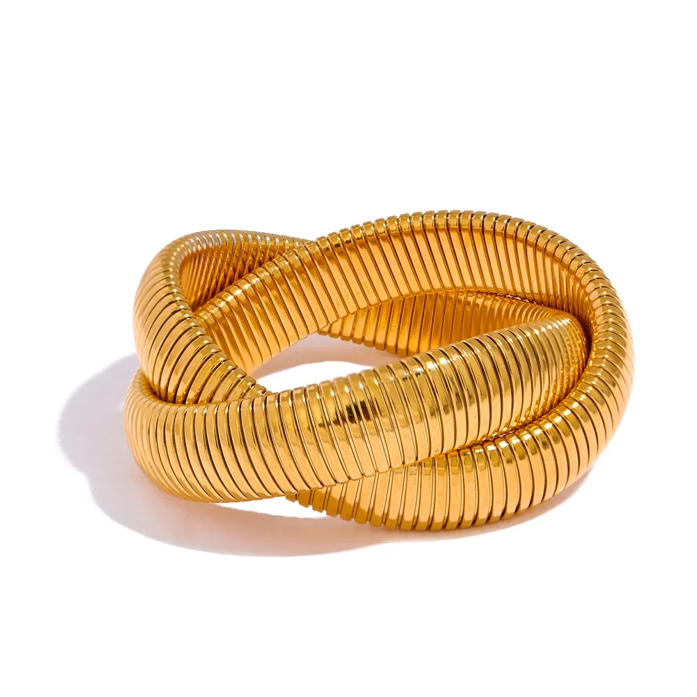 Gold-plated wide stackable cuff bracelet used as the anchor piece in a bangle stack