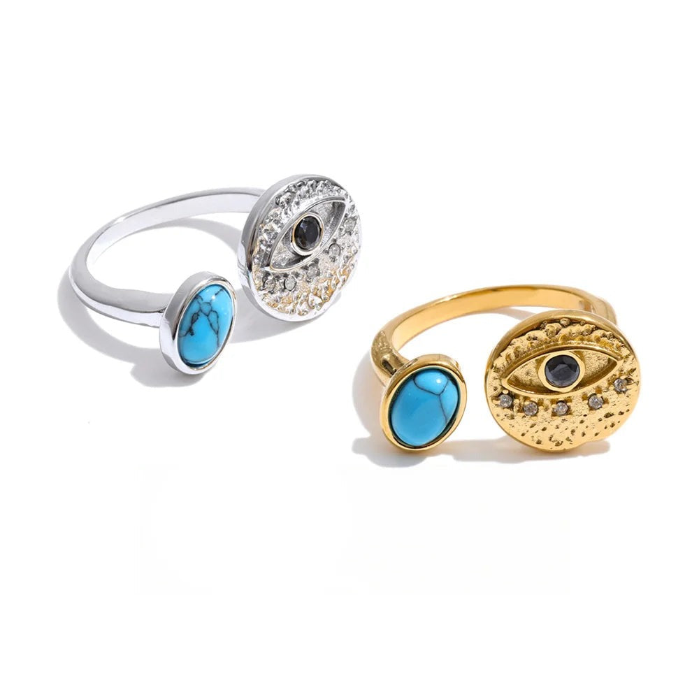Ring with gold-plated stainless steel band, cubic zirconia stones, and a blue stone in the center.