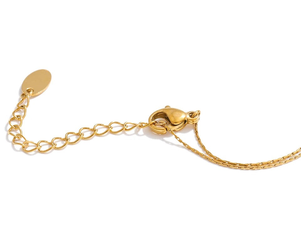 Cubic zirconia beaded geometric necklace in gold-plated stainless steel with cubic zirconia.