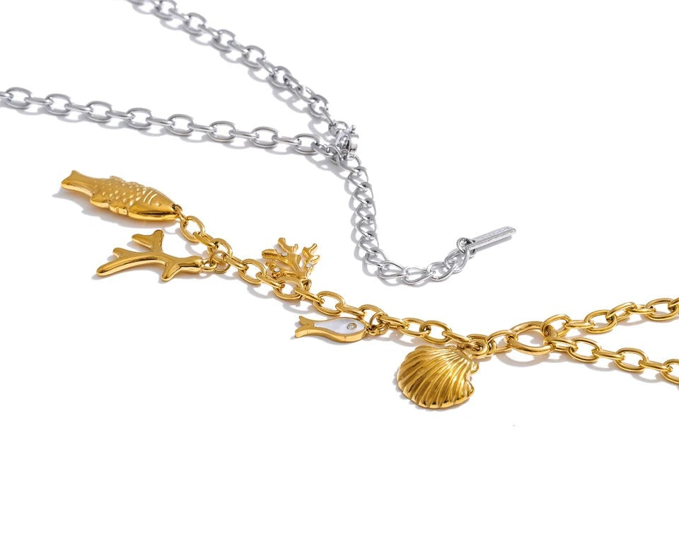Cubic zirconia shell geometric necklace in gold-plated stainless steel with cubic zirconia and shell.