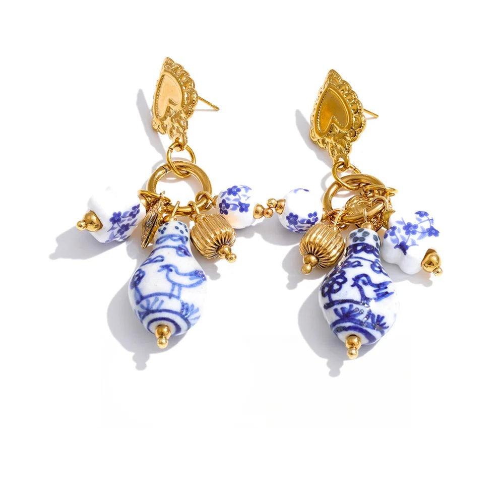 Gold-plated stainless steel earrings with blue and white enamel accents.