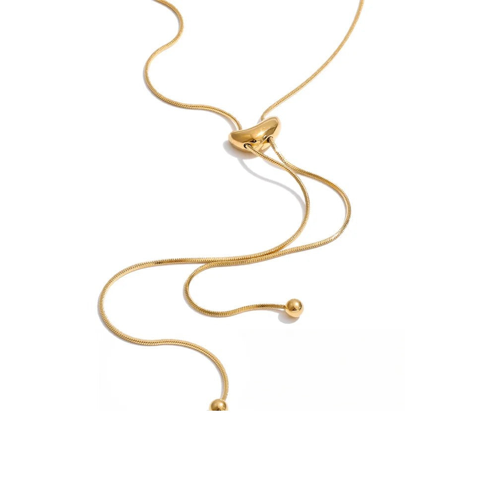 Gold-plated stainless steel necklace with a curved chain and a pendant featuring two small spheres connected by a thin rod.