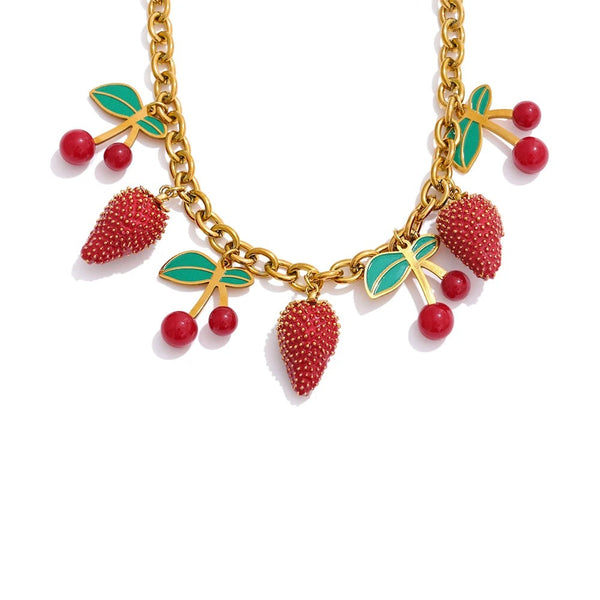 Gold-plated necklace with red berries and green leaves.