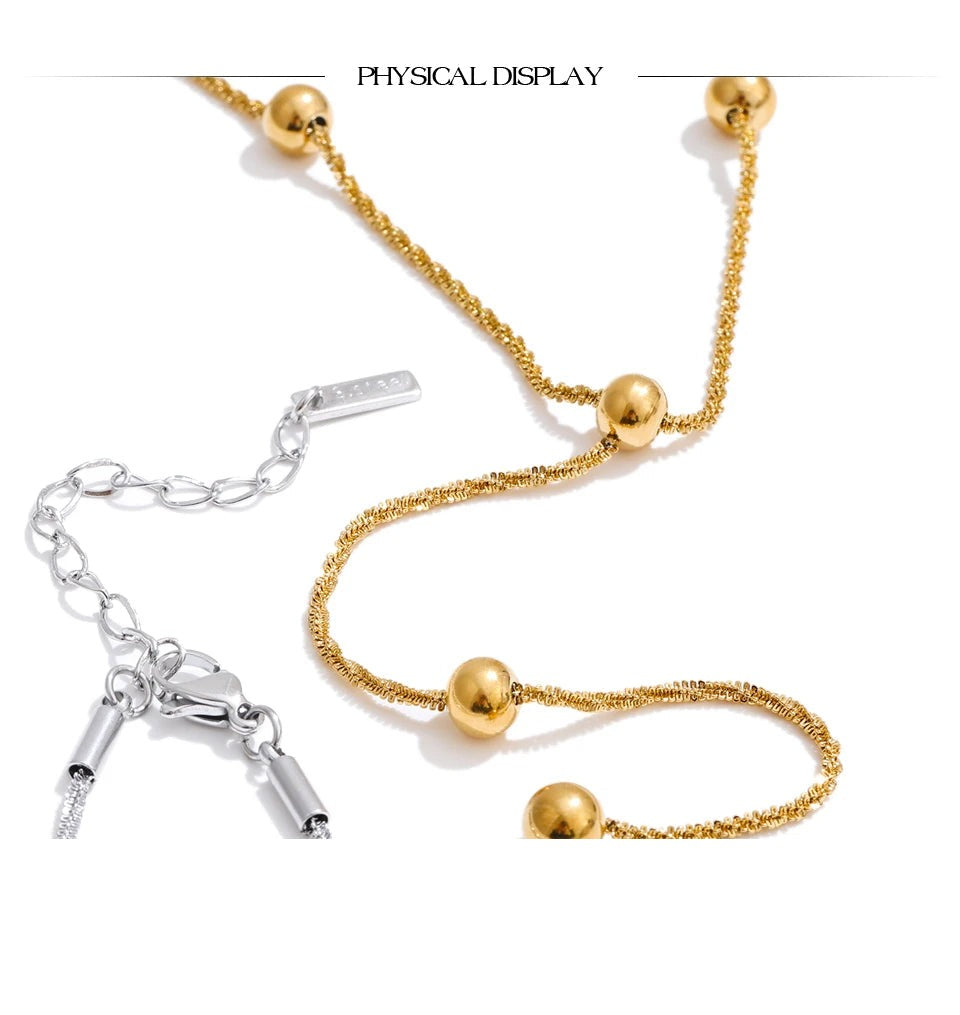 Beaded geometric chain necklace in gold-plated stainless steel.