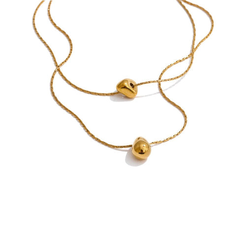 Gold-plated stainless steel necklace with a small ball pendant.