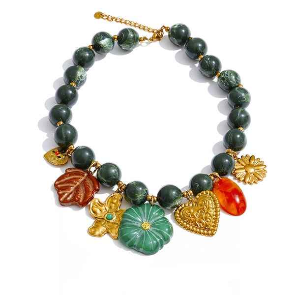 Gold-plated stainless steel necklace with resin and acrylic beads, featuring a variety of colorful leaves and a green stone.