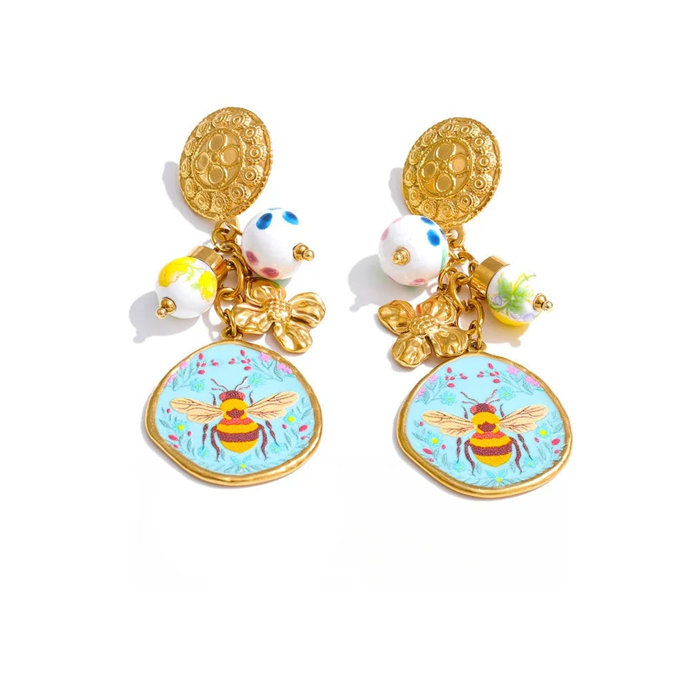 Gold-plated stainless steel earrings featuring a bee design with a floral pattern and a small honeycomb charm.