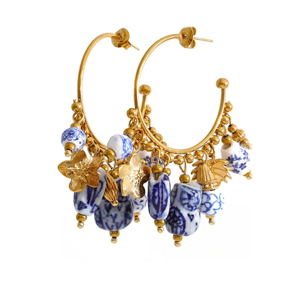 Gold-plated stainless steel earrings with a floral design featuring blue and white stones.