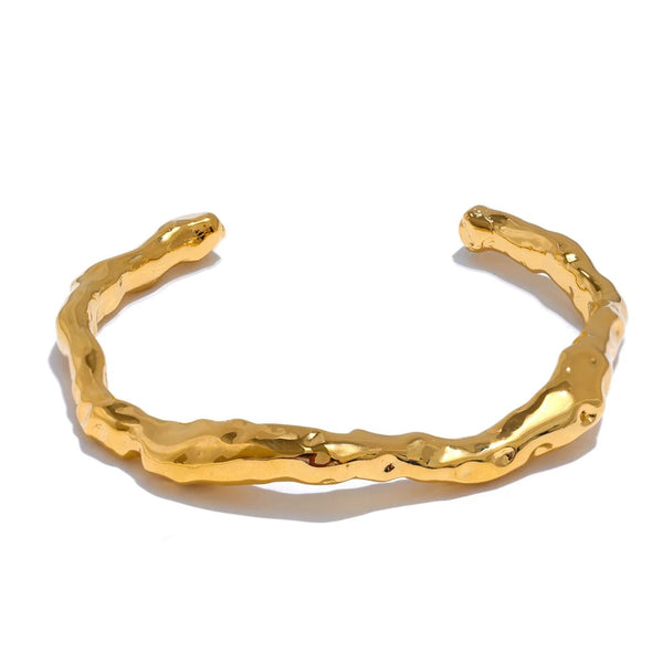 Gold-plated stainless steel bracelet with a unique, wavy design.