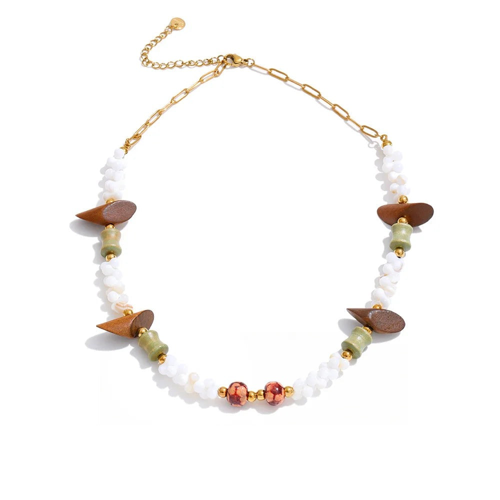 Gold-plated stainless steel necklace with shells and red stone accents.