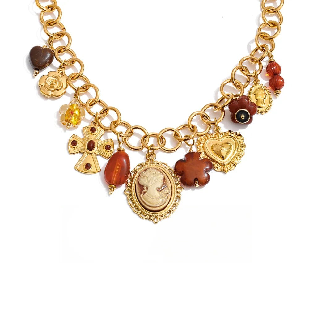 Gold-plated stainless steel necklace with resin and acrylic detailing a medallion pendant featuring a portrait of a person surrounded by various charms.