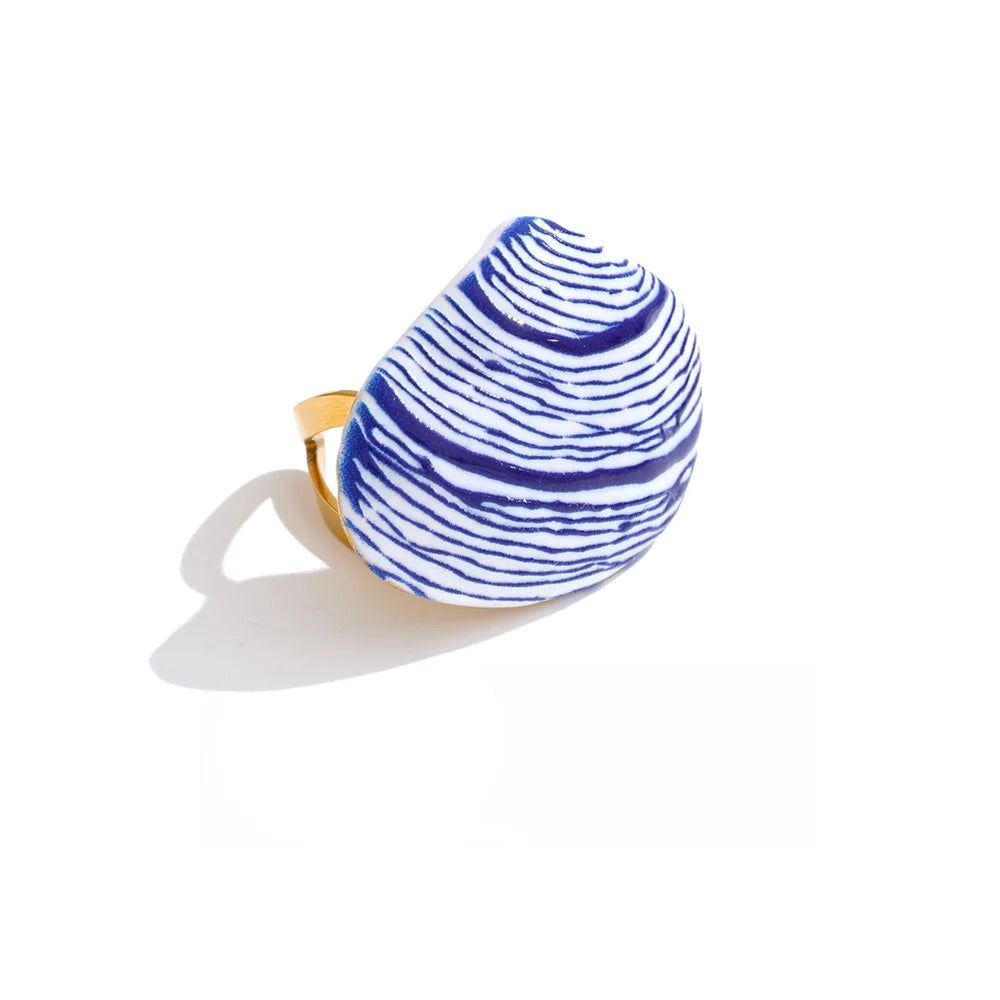Gold-plated ring with blue and white enamel design.