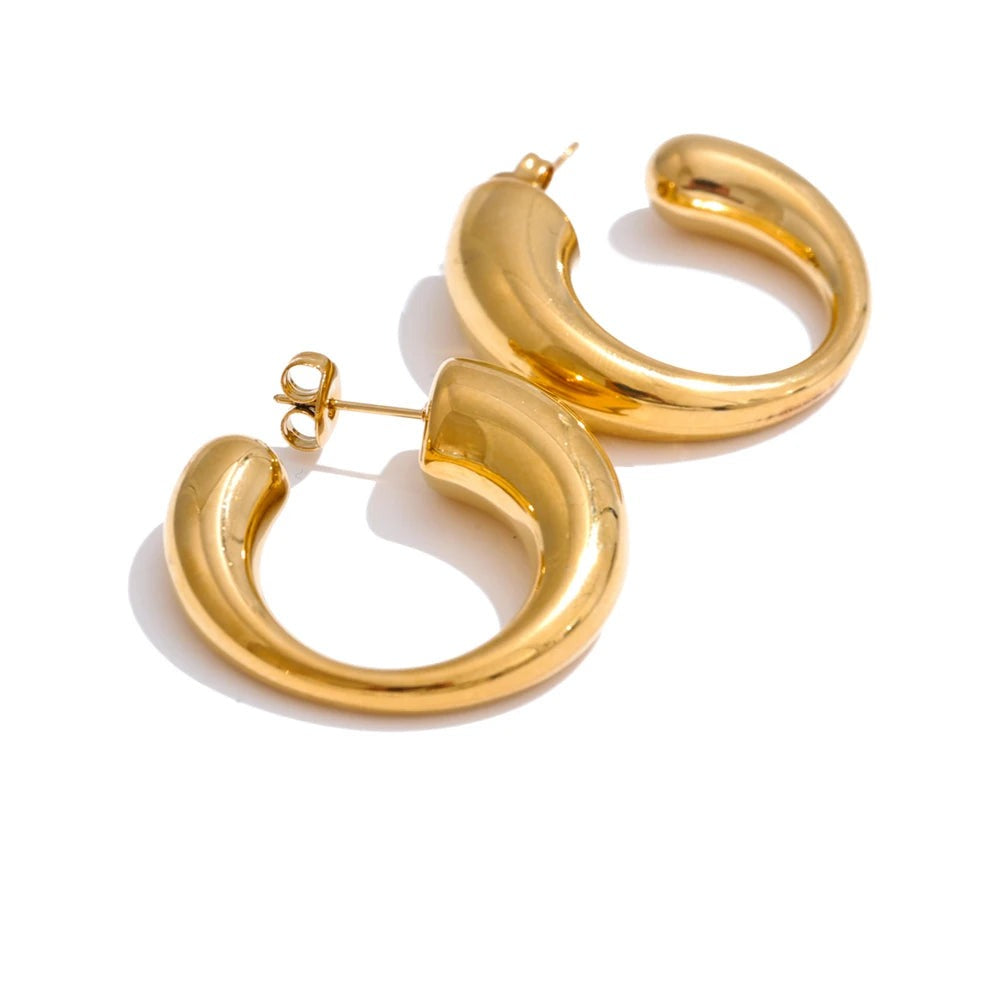 Gold-plated stainless steel hoop earrings with a large circular design.