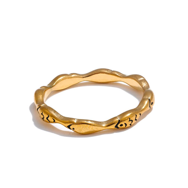 Gold-plated ring with a large, intricate band design.