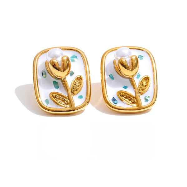 Gold-plated stainless steel earrings with pearl and enamel detailing a flower.