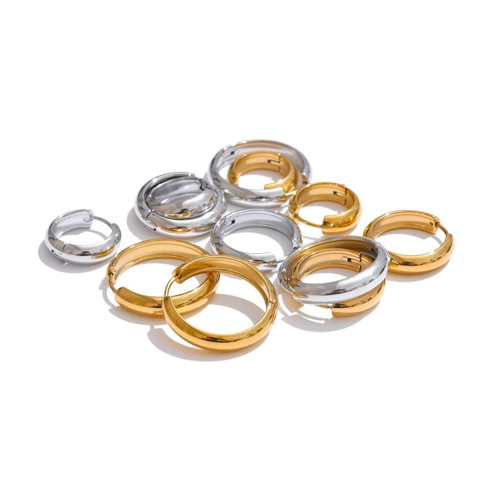 Gold-plated stainless steel earrings in a pile.