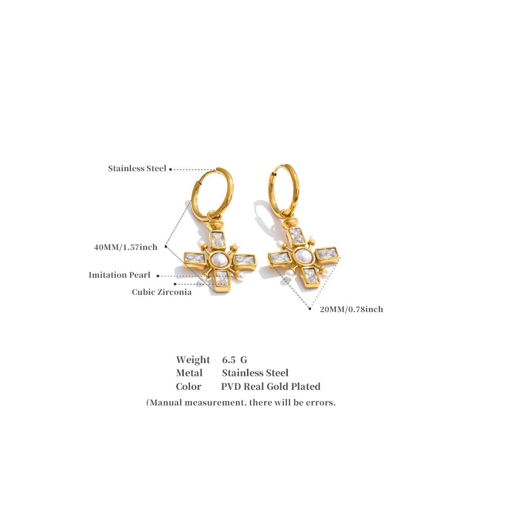 Cubic zirconia pearl cross earrings in gold-plated stainless steel with pearl and cubic zirconia.