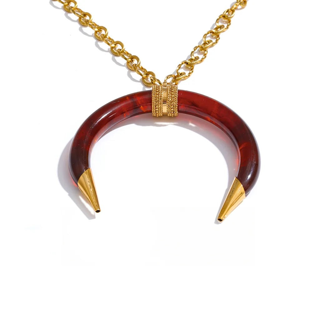 Gold-plated stainless steel necklace with red resin crescent moon pendant.