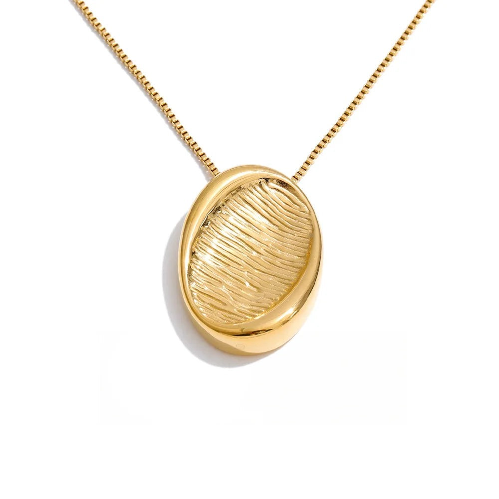 Gold-plated stainless steel necklace with a leaf-shaped pendant.