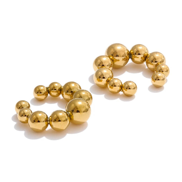 Gold-plated ball earrings with a shiny finish.