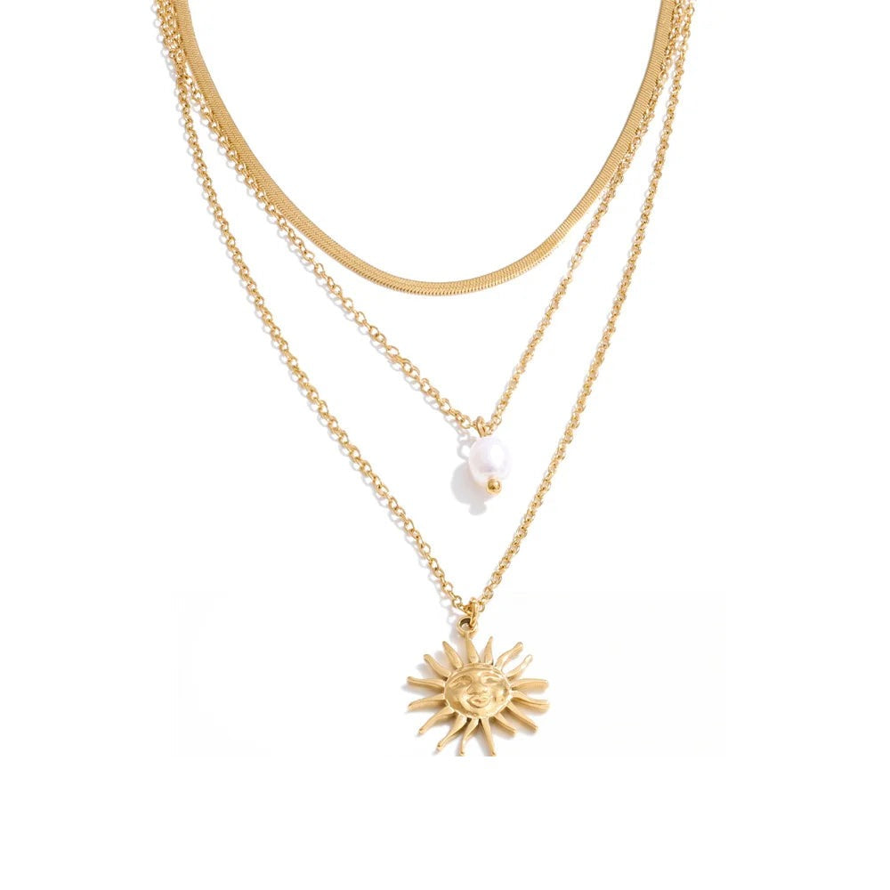 Gold-plated stainless steel necklace with pearl pendant and sun charm.