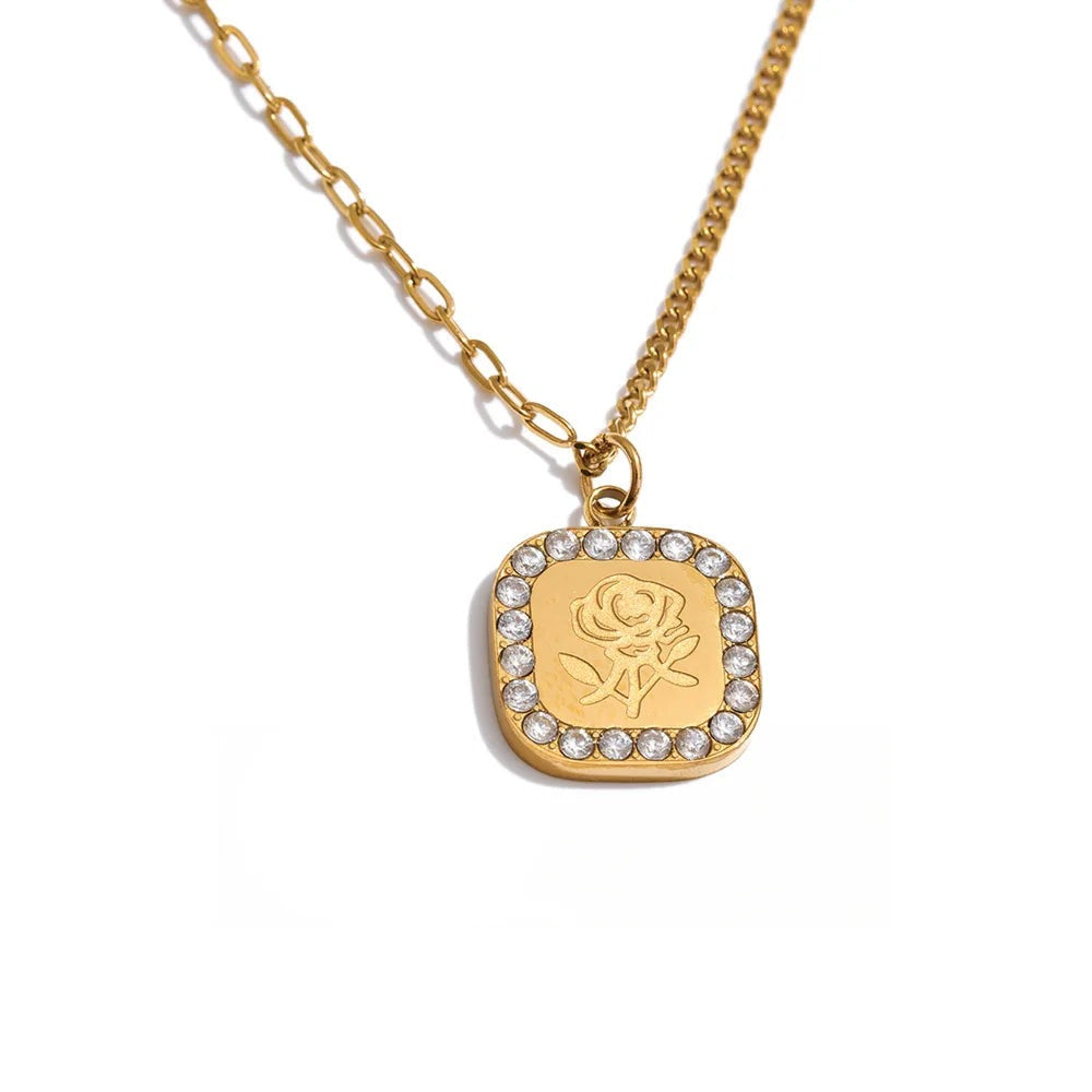 Gold-plated stainless steel necklace with cubic zirconia flower pendant.