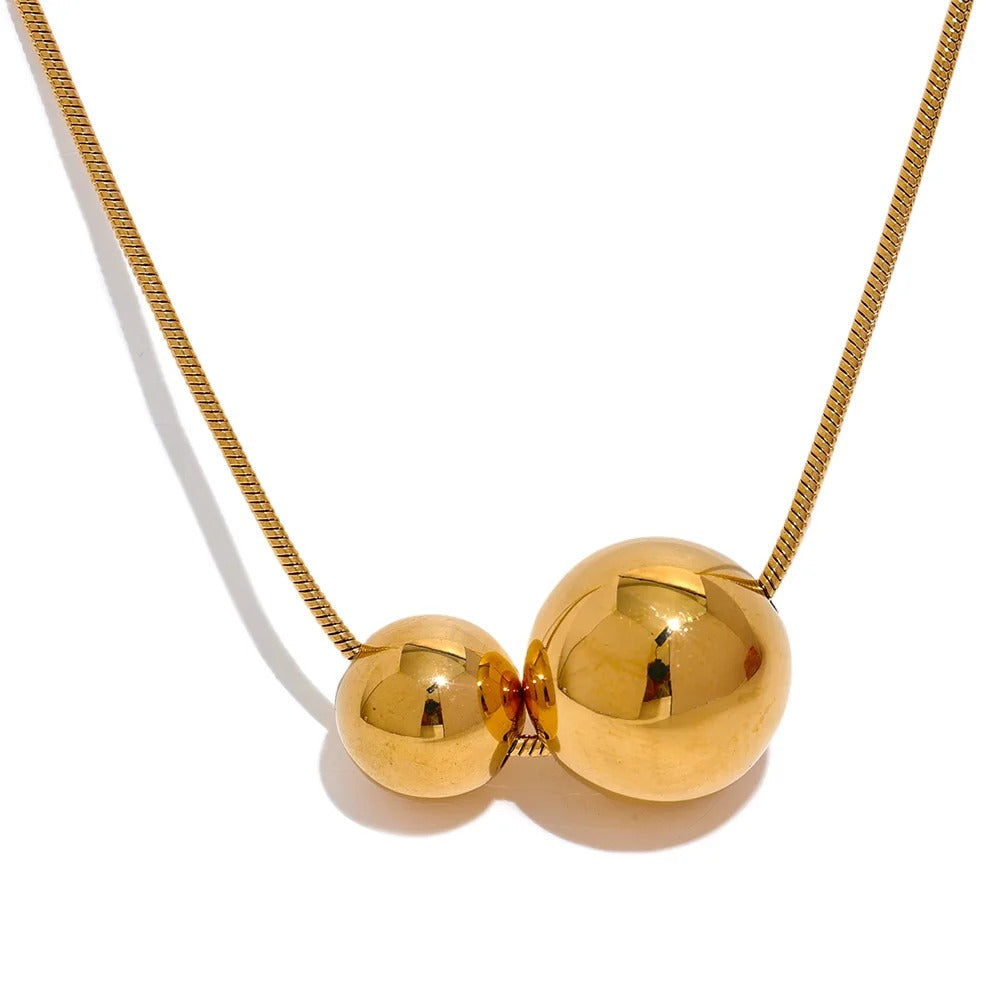 Gold-plated stainless steel necklace with two spherical pendants.
