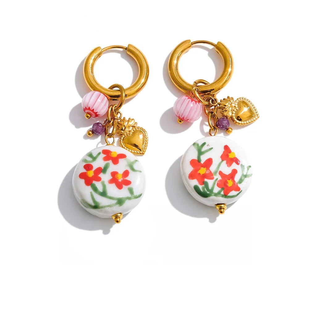 Gold-plated stainless steel earrings with a floral design and a small flower charm.