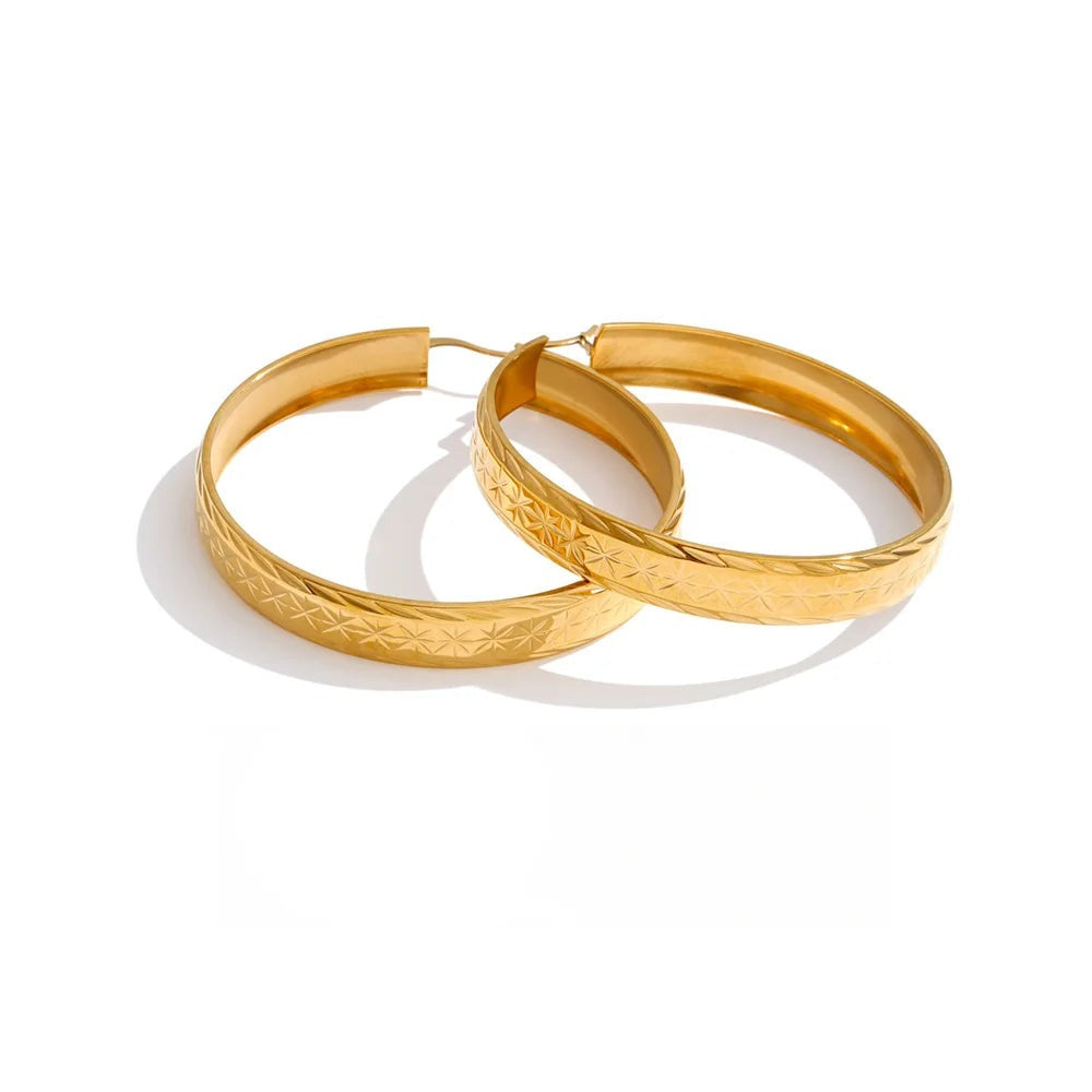 Gold-plated stainless steel hoop earrings.