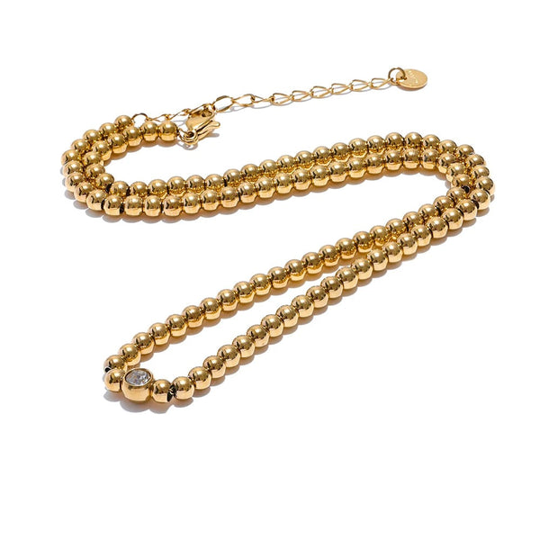 Gold-plated stainless steel necklace with cubic zirconia beads.
