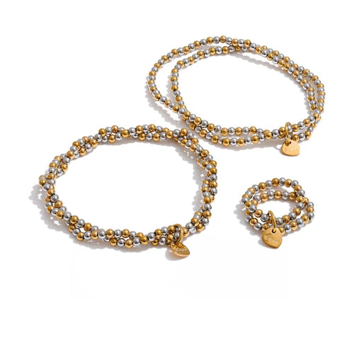 Gold-plated stainless steel bracelet with a small charm.