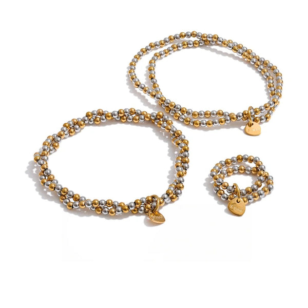Gold-plated stainless steel bracelet with a small charm.