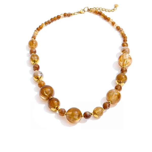 Gold-plated necklace with pearl and resin beads.