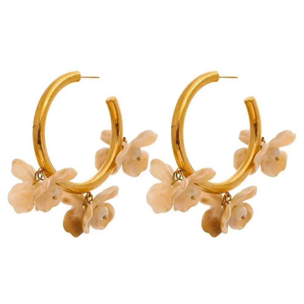 Gold-plated stainless steel hoop earrings with resin detailing a floral design.