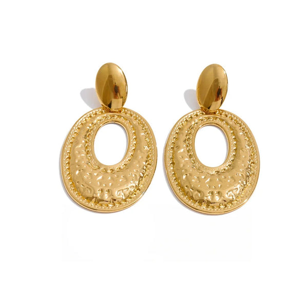 Gold-plated stainless steel earrings with a large circular design on each hoop.