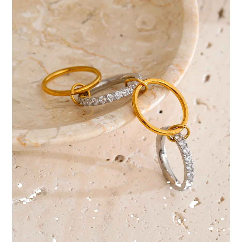 Cubic zirconia geometric layered ring in 18K gold-plated stainless steel with cubic zirconia.