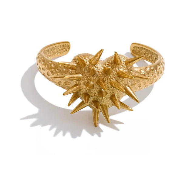 Gold-plated stainless steel bracelet with a spiked design.