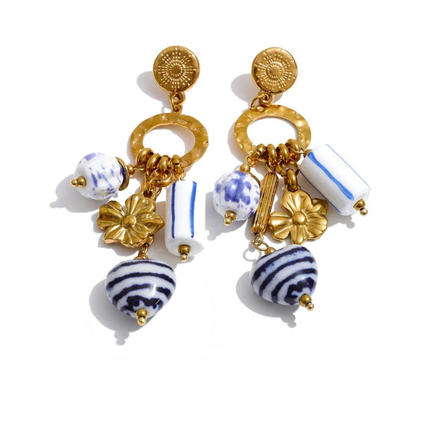 Gold-plated stainless steel earrings with a blue and white flower design.