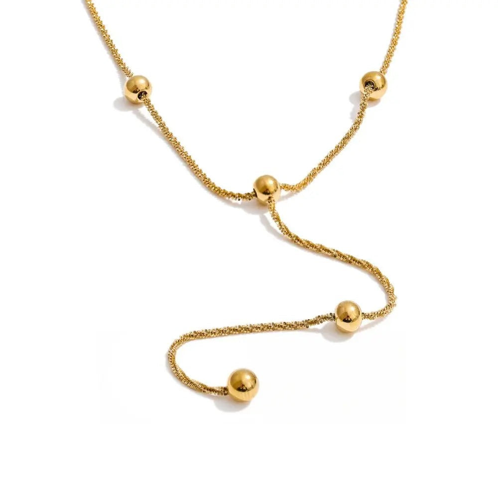 Gold-plated stainless steel necklace with a curved chain.