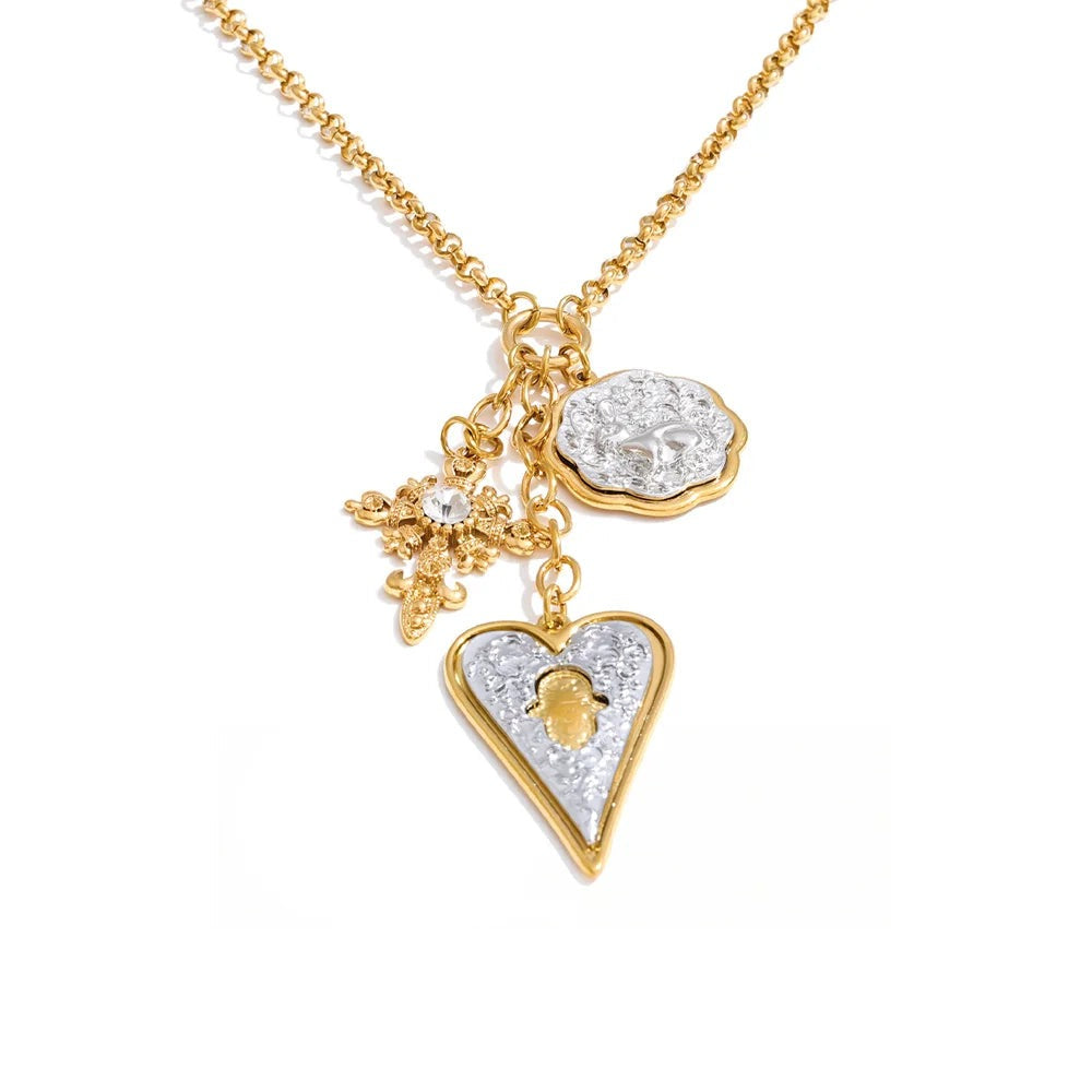 Gold-plated stainless steel necklace with a heart pendant featuring a diamond and a small cross charm.