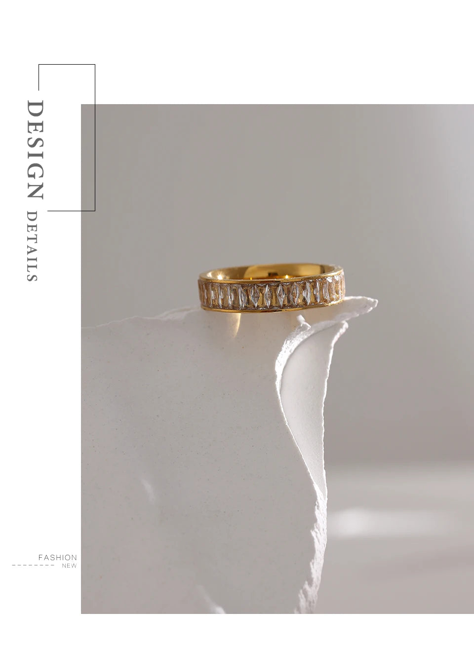 Cubic zirconia geometric ring in 18K gold-plated stainless steel with cubic zirconia.