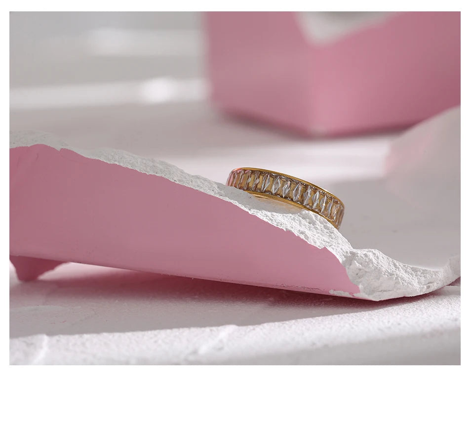 Cubic zirconia geometric ring in 18K gold-plated stainless steel with cubic zirconia.