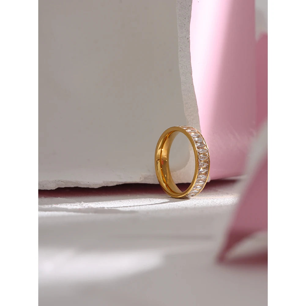 Cubic zirconia geometric ring in 18K gold-plated stainless steel with cubic zirconia.
