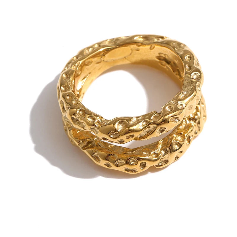 Gold-plated stainless steel ring with intricate design.